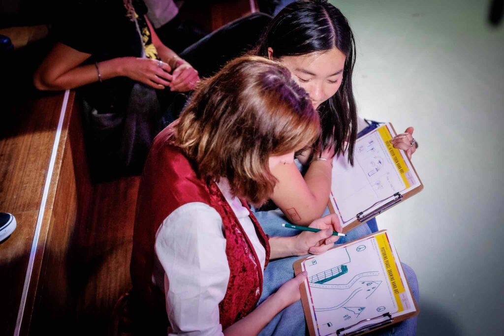 Image 1: Festival visitors complete the ‘peace drawing hand-out’. Photo credits: Ben Houdijk